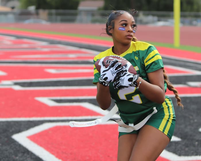 A flag football hopeful clutches a pass tightly. Photo: John Murphy